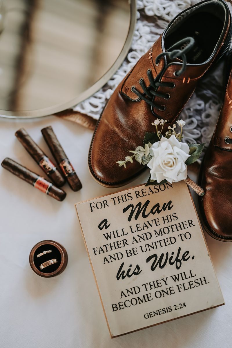 Groom's shoes, cigars, rings and a Genesis 2:24 sign