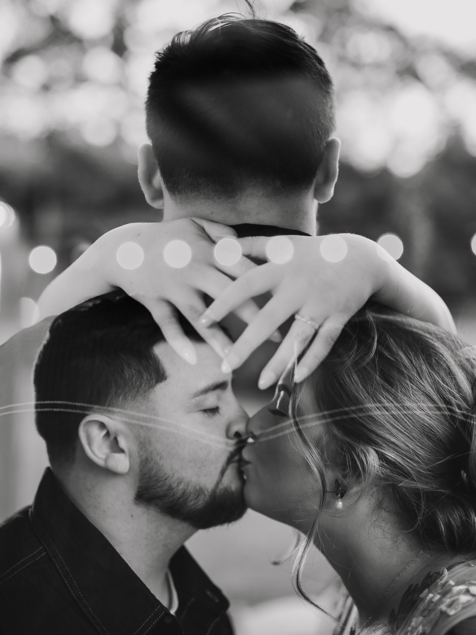 Bride wrapping her arms around her groom's head as they touch foreheads