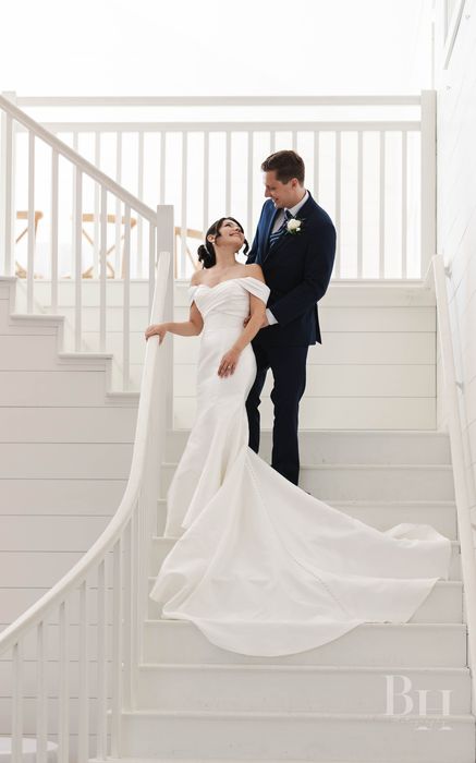 Bride and groom on a white staircase