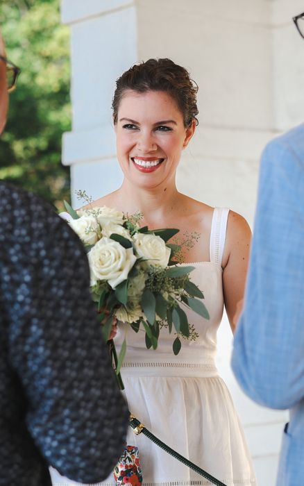Smiling bride holding her bouquet